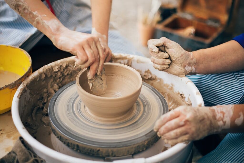 photo of pottery on the wheel